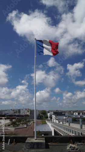 flag on the pier in the sky with clouds, Montoir St Nazaire, Bretagne, France
