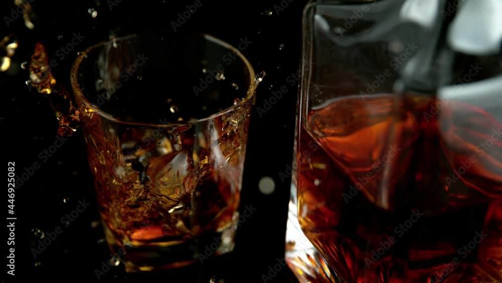 Super slow motion of falling ice cube into whiskey drink. Speed ramp effect. Filmed on high speed cinema camera, 1000 fps. Super slow motion of falling ice cube into whiskey drink. Speed ramp effect. Filmed on high speed cinema camera, 1000 fps.