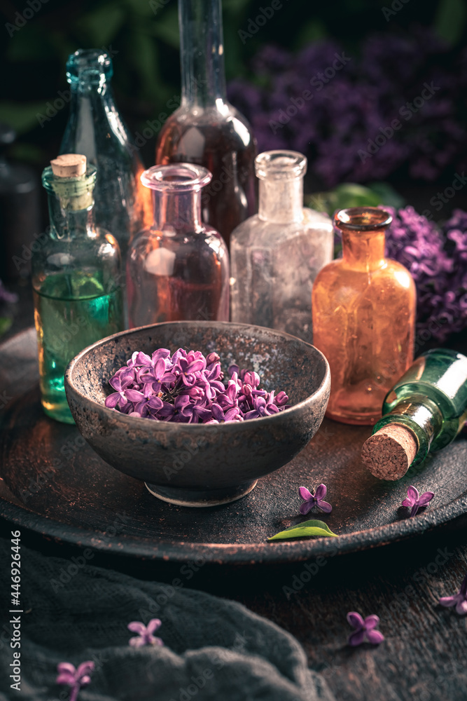 Unique glass with flower lilac oil. Lilac flower products. Unique glass with flower lilac oil. Lilac flower products.