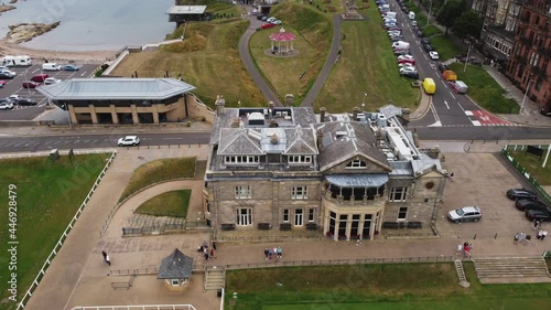 Low-level aerial footage of the Royal and Ancient Club house in the historic town of St. Andrews, Fife, Scotland. With the World Golf Museum and bandstand in the background.
