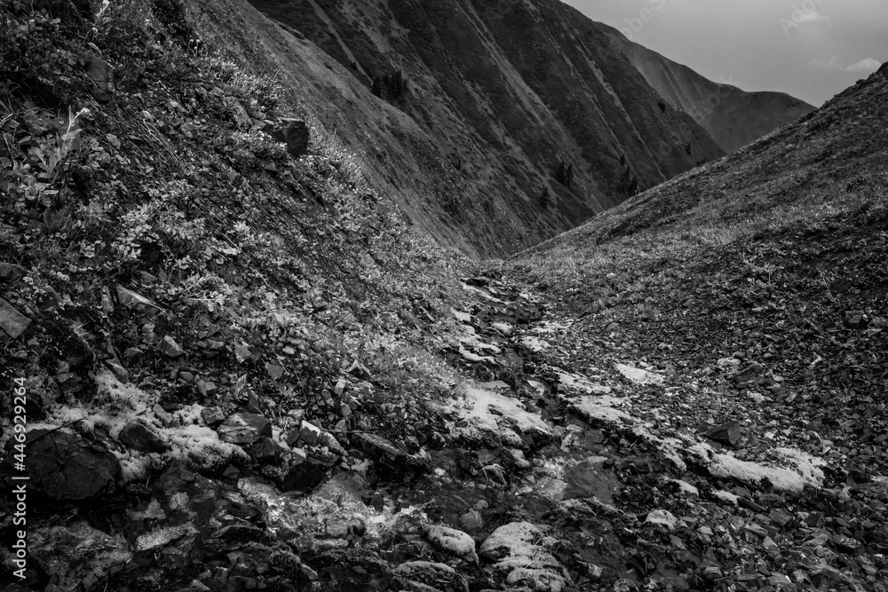 Monochrome scenery: mountains and the thin mountain river
