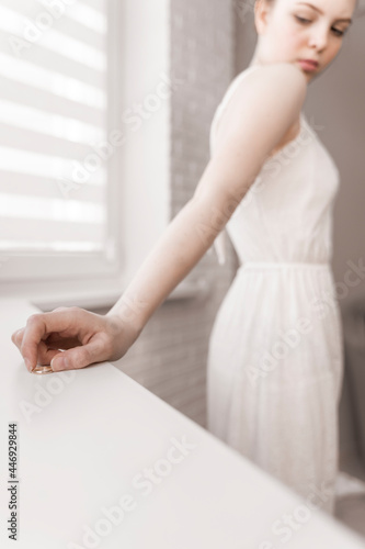 unhappy young woman took off wedding ring looking at jewellery thinks sad thoughts about cheating husband, makes divorce decision, pass through family split, break up and separation concept