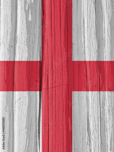 The flag of England on a dry wooden surface, cracked with age. It seems to flutter in the wind. Vertical illustration with national symbol. Saint George's Cross. Hard sunlight with shadows