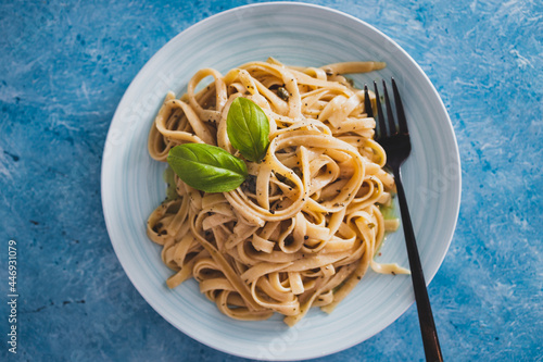 vegan fettuccini pasta with lemon sauce and pepper, healthy plant-based food