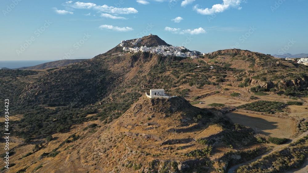Aerial drone photo from uphill Venetian castle and small chapel overlooking the Aegean sea on top of scenic cliff in chora, capital of Milos island, Cyclades, Greece Aerial drone photo from uphill Venetian castle and small chapel overlooking the Aegean sea on top of scenic cliff in chora, capital of Milos island, Cyclades, Greece