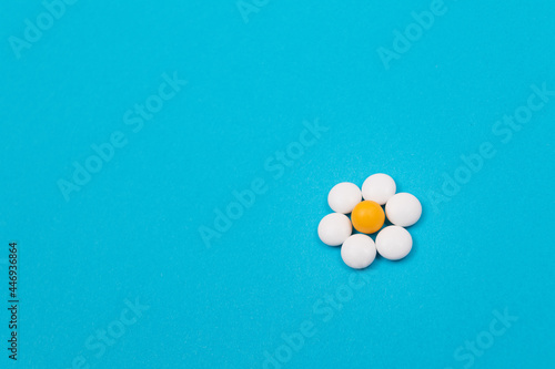 Global Pharmaceutical Industry and Medicinal Products - White Pills or Tablets Lying on Blue Background