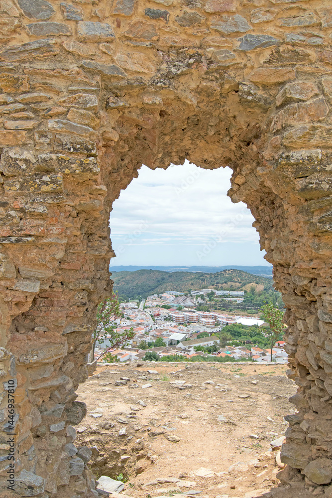Opening in the castle of Constantina with the town in the background, Seville, Andalusia, Spain