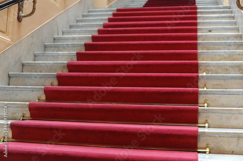 Red carpet for stars and celebrities on a marble staircase for festivals, awards, celebrations and prestigious events