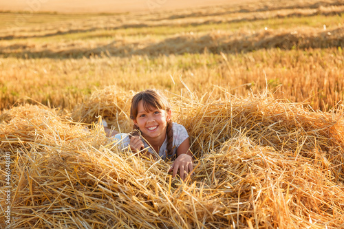 Girl in a wheat field at sunset © Ирина Савченко