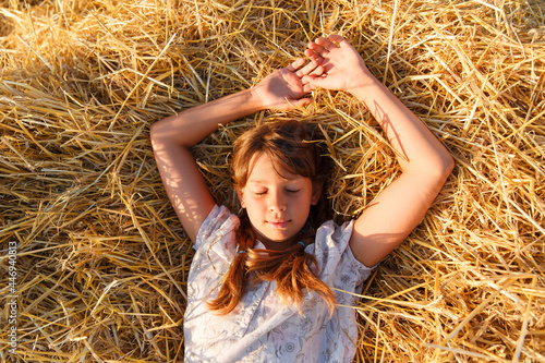 Girl in a wheat field at sunset