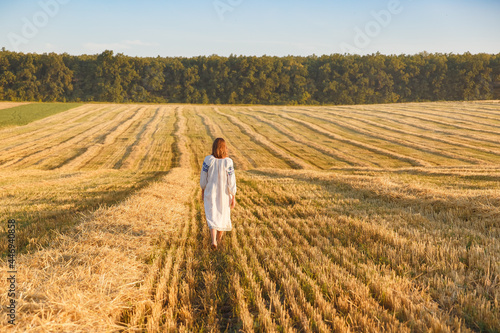 Girl in a wheat field at sunset