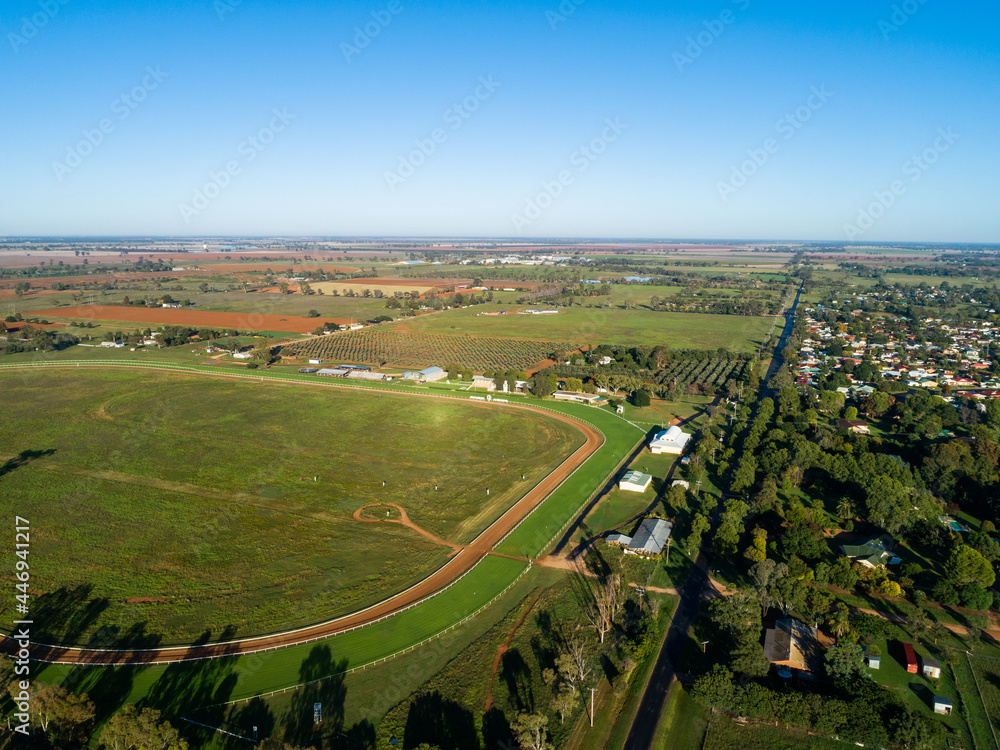 Empty country showground oval and racecourse seen from the air on sunlit day Empty country showground oval and racecourse seen from the air on sunlit day