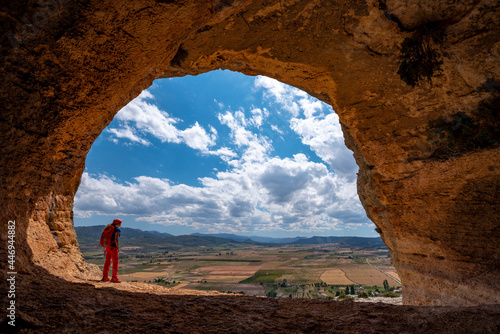 A women hiking a scenic trail under a giant overhang Caves of Zaen photo