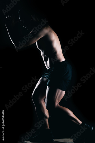 Strong man doing exercises on top of a box. © Samuel Perales