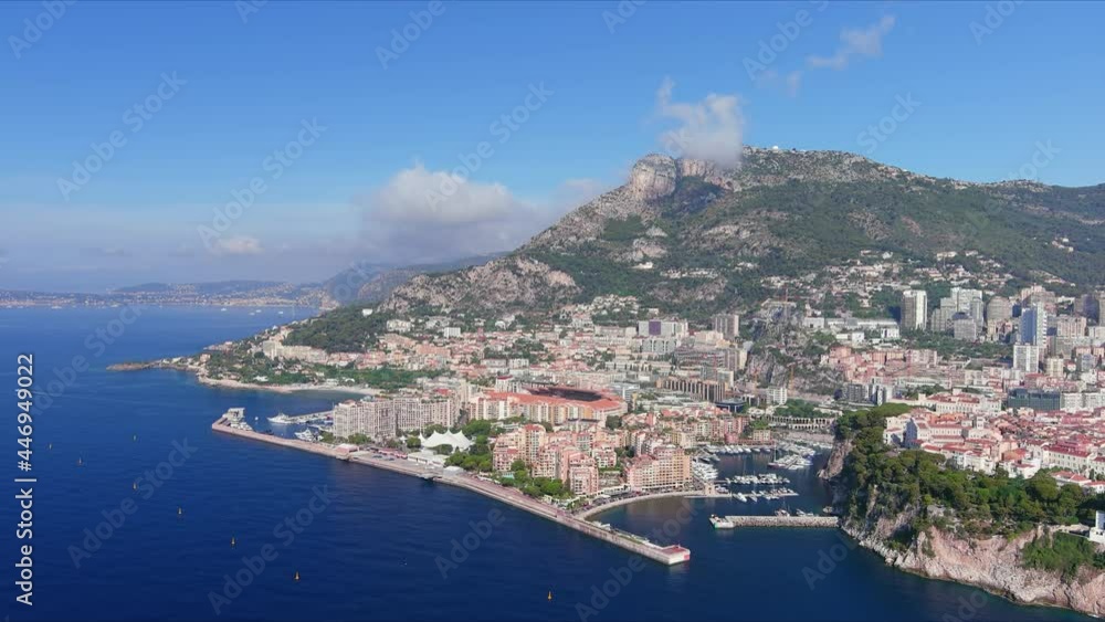 Monte Carlo, Monaco. Aerial view of famous city towering over Mediterranean Sea, ships and boats in yachting marina Port de Fontvieille - landscape panorama of Europe from above Monte Carlo, Monaco. Aerial view of famous city towering over Mediterranean Sea, ships and boats in yachting marina Port de Fontvieille - landscape panorama of Europe from above