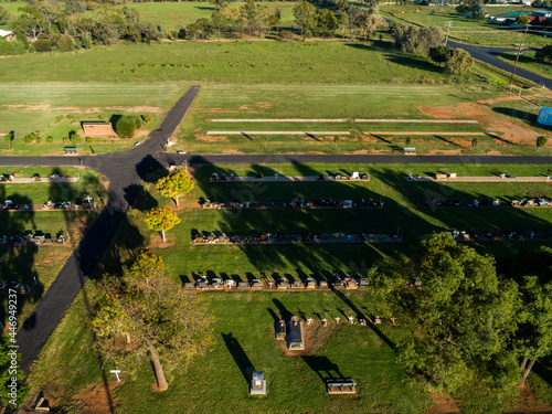 Aerial image of rural country cemetery with space for new graves and green lawn photo