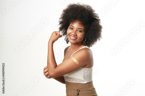 Bilde på lerret beautiful happy young african female after vaccine injection on white background