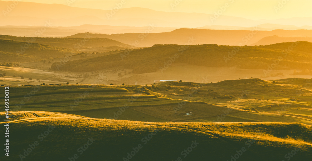 autumn landscape with hills in sunset light