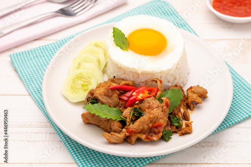 Spicy stir-fried pork slices with holy basil leaves served with steamed fragrant jasmine rice topped with a fried egg or khao ka prao moo khai dao, a popular single dish for many Thais. 