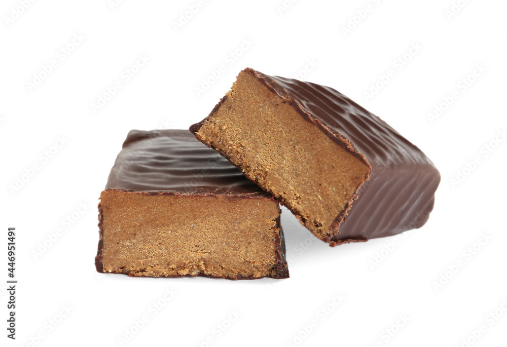 Halves of tasty chocolate glazed protein bar on white background Halves of tasty chocolate glazed protein bar on white background