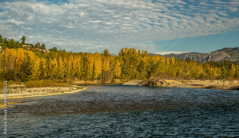 The turquoise waters of Köprüçay, a rafting center, and the yellow of autumn around it