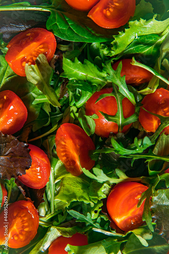 Mediterranean salad with cherry tomatoes, spinach and greenery. Healthy fresh salad of vegetable, tomatoes, spinach, arugula