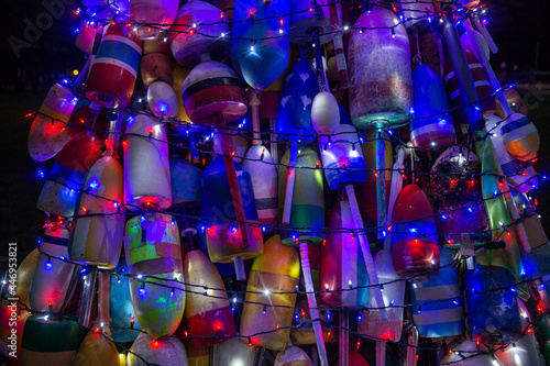 weathered fishing buoys with Christmas lights. beautiful holiday background photo