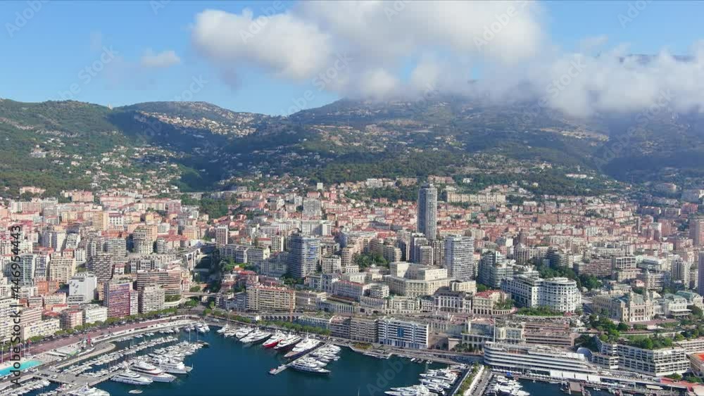 Monte Carlo, Monaco. Aerial view of famous city towering over Mediterranean Sea, Monte Carlo Casino in center of city, marina Port Hercules, clear blue sky - landscape panorama of Europe from above Monte Carlo, Monaco. Aerial view of famous city towering over Mediterranean Sea, Monte Carlo Casino in center of city, marina Port Hercules, clear blue sky - landscape panorama of Europe from above