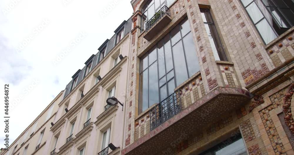 Exterior Detail Of Art Deco Building In Rue Campagne Premiere, 14th Arrondissement Of Paris, France. Bow Window And Balcony Of An Artist Studio. low angle, slider right Exterior Detail Of Art Deco Building In Rue Campagne Premiere, 14th Arrondissement Of Paris, France. Bow Window And Balcony Of An Artist Studio. low angle, slider right