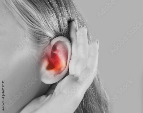 Woman suffering from earache, closeup. Black and white tone photo