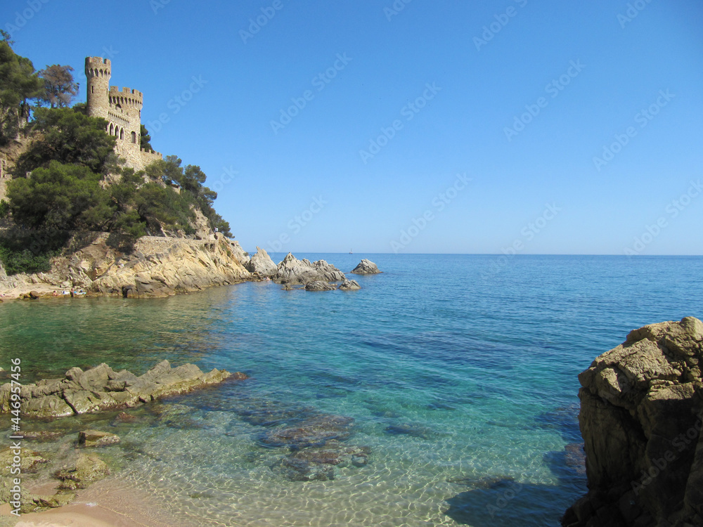 clear water and a castle on the shore