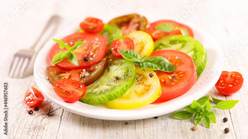 colorful fresh tomato salad with basil