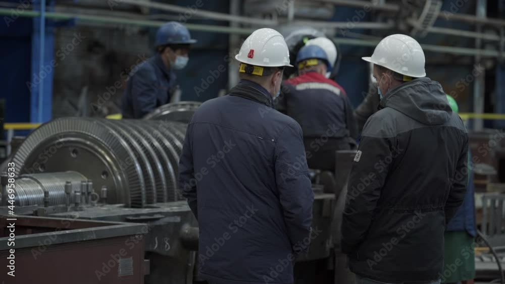 Turbine Manufacturing Process. Multiple Workers Wearing the Safety