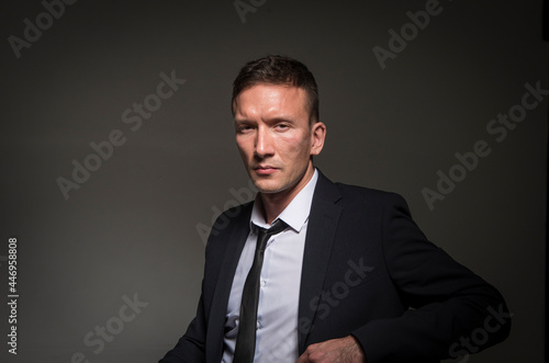 portrait of a businessman. Man in a black suit and tie. Portrait of a businessman against a dark background with copy space.