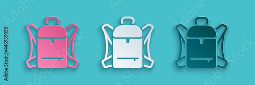 Paper cut Hiking backpack icon isolated on blue background. Camping and mountain exploring backpack. Paper art style. Vector