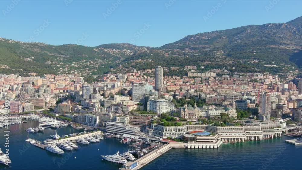 Monte Carlo, Monaco. Aerial view of famous city towering over Mediterranean Sea, Monte Carlo Casino in center of city, marina Port Hercules, clear blue sky - landscape panorama of Europe from above Monte Carlo, Monaco. Aerial view of famous city towering over Mediterranean Sea, Monte Carlo Casino in center of city, marina Port Hercules, clear blue sky - landscape panorama of Europe from above