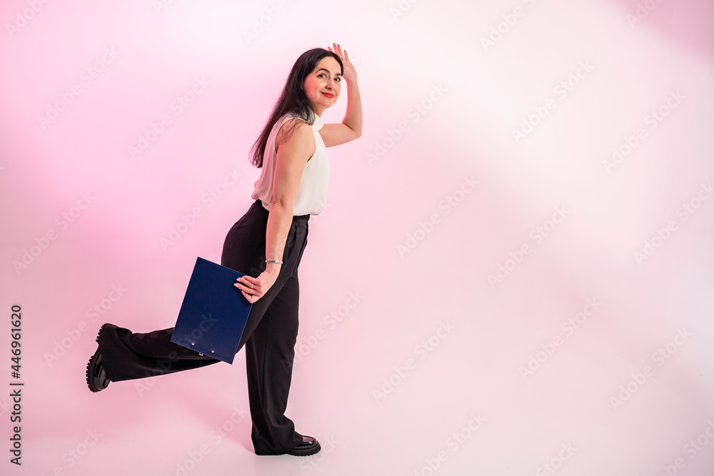 Portrait of a smiling beautiful business woman on a pink background. Happy cheerful business woman. Full-length portrait. Portrait of a smiling beautiful business woman on a pink background. Happy cheerful business woman. Full-length portrait.