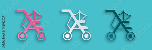 Paper cut Baby stroller icon isolated on blue background. Baby carriage, buggy, pram, stroller, wheel. Paper art style. Vector