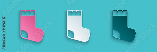 Paper cut Baby socks clothes icon isolated on blue background. Paper art style. Vector
