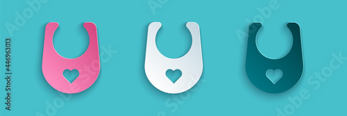 Paper cut Baby bib icon isolated on blue background. Paper art style. Vector