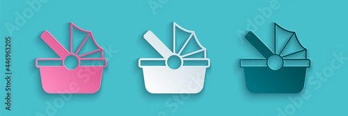 Paper cut Baby stroller icon isolated on blue background. Baby carriage, buggy, pram, stroller, wheel. Paper art style. Vector