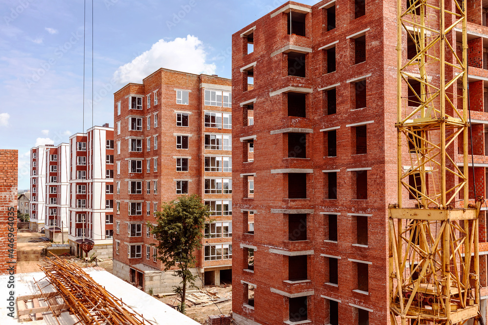 Fototapeta premium Construction of a block of multi-storey brick houses
