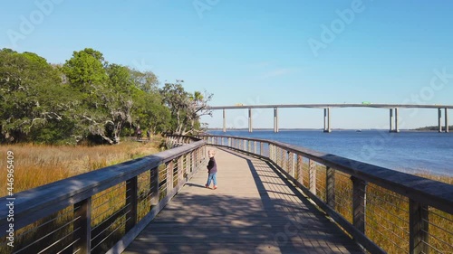 A toddler runs along the boardwalk on Daniel Island in South Carolina photo
