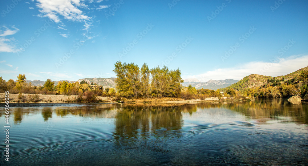 The turquoise waters of Köprüçay, a rafting center, and the yellow of autumn around it