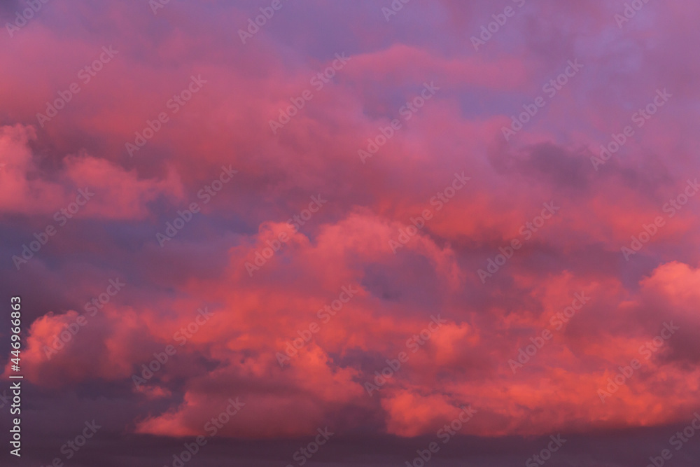 Epic Dramatic sunrise, sunset orange pink red clouds in sunlight on storm sky background texture