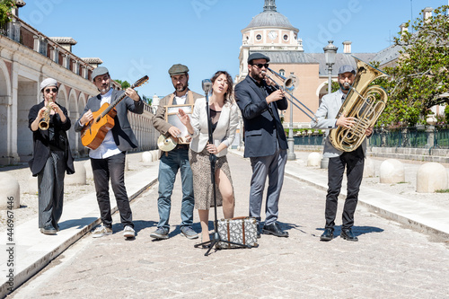 Jazz band playing in the street in broad daylight composed of 6 components