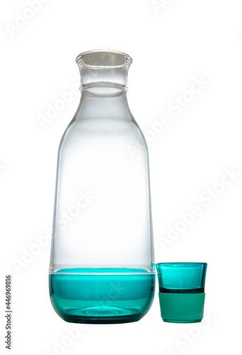 Clear glass water bottle with blue lid on white background