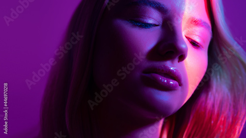 Portrait with neon-style lighting, a young beautiful blonde