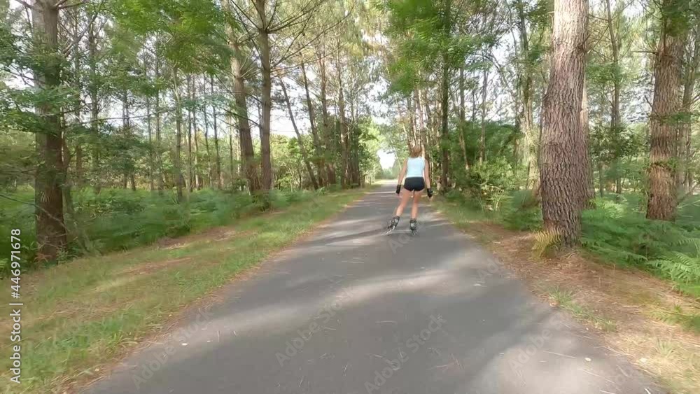 beautiful young woman inline skating on the bike path beautiful young woman inline skating on the bike path