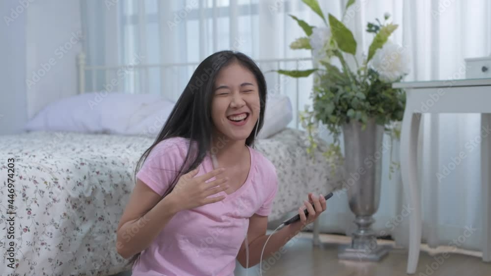 Holiday concept of 4k Resolution. Asian girls are enjoying music in the bedroom. Holiday concept of 4k Resolution. Asian girls are enjoying music in the bedroom.